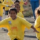 Children in yellow shirts run down a path or trail at Don Edwards San Francisco Bay National Wildlife Refuge