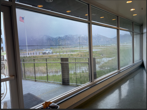 large windows with overcast sky and mountains in background