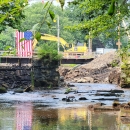 A river passes through a partially deconstructed dam
