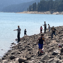 Children fishing at a reservoir on a summer day