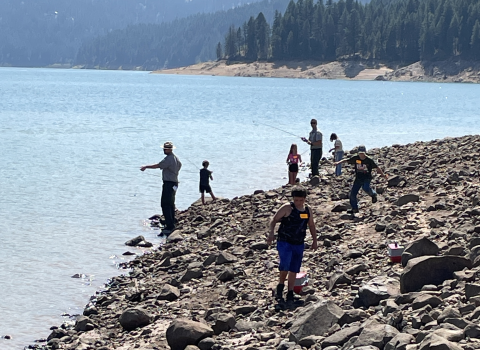 Children fishing at a reservoir on a summer day