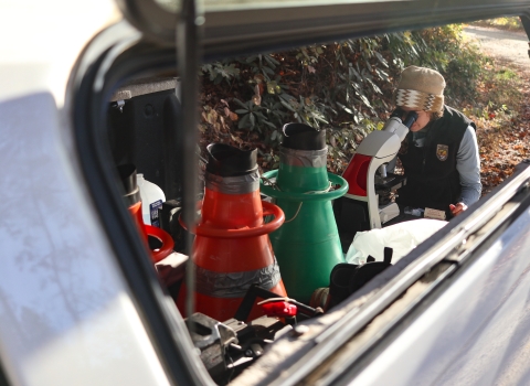 Woman at a microscope set up at at pickup truck