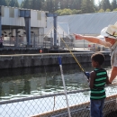 Williard National Fish Hatchery employee Pat Cushman assists with Kid's Fishing Day 2015
