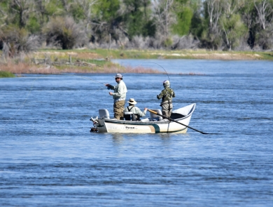 3 people in boat fishing