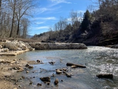 Three images of the dam. 1. Full dam on a rocky stream, 2. Partial dam, part of the structure is gone, 3. open river bed and earthen streambanks held in place with canvas and rock.