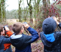 Three boys with binoculars
