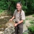 USFWS employee holding softshell turtle in stream