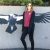 a woman standing by a picture of a large bird