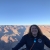 Rachel Stearns, biological technician at Rachel Carson National Wildlife Refuge, poses before a southwestern panorama of canyonlands with bright blue ski above.