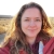 Photo of Jodie Delavan, USFWS employee in front of field at sunset