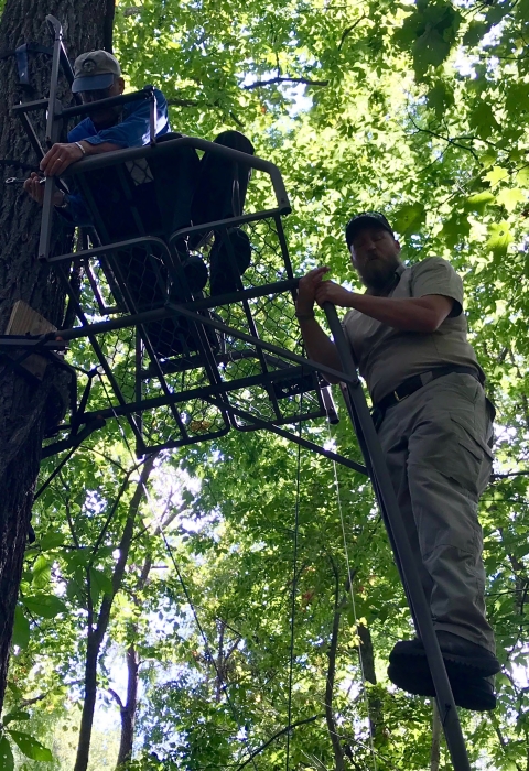 Fish and Wildlife Service employees repairing deer stand