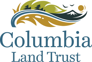 A logo with tree, mountain, and river artwork with the words "Columbia Land Trust"