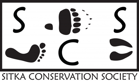 black and white logo with human and animal footprints with the letters SCS