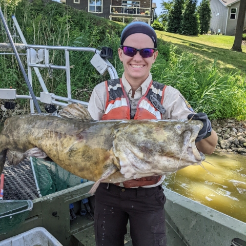 Employee holding a large fish.