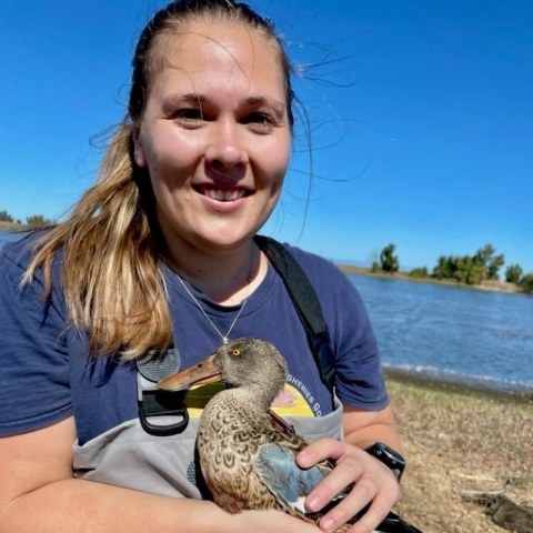 Photo of Emily Shakeri-Wells holding a Northern Shoveler