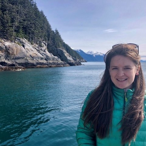 Carol Mahara smiles with the ocean and seaside in the background. 