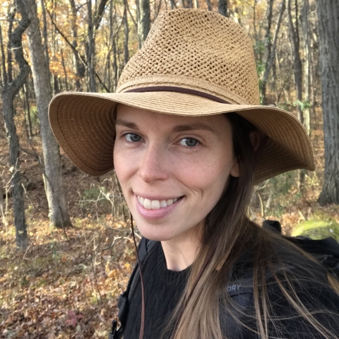 Girl with hat on smiling for camera
