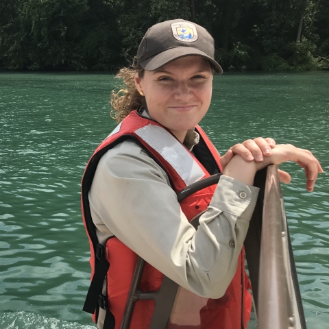 Fish and Wildlife Service Biologist in a life jacket on a boat