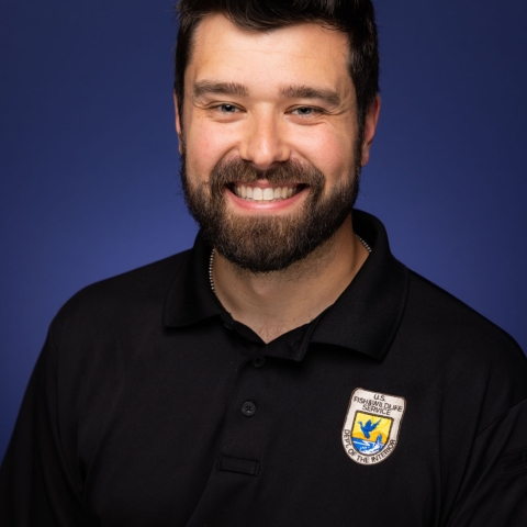 Headshot of Ty Wallin in a black U.S. Fish and Wildlife Service Polo