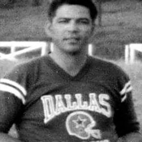 A black and white headshot of a John T. Cantu smiling.