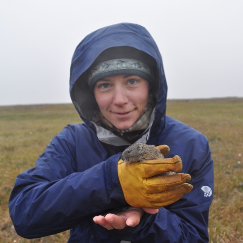 woman in rain gear holding a lemming