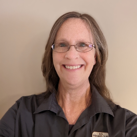 A woman wearing a dark gray shirt. 