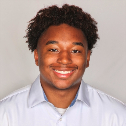 Charles Davis smiles into the camera for a headshot portrait