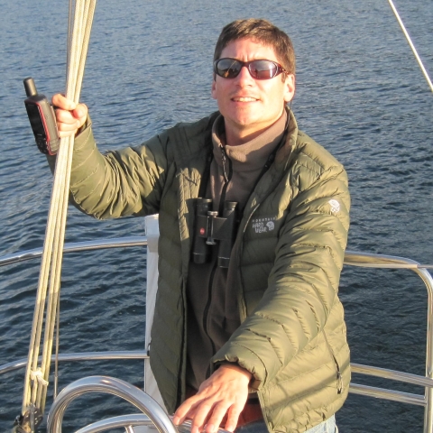 man standing on the deck of a boat