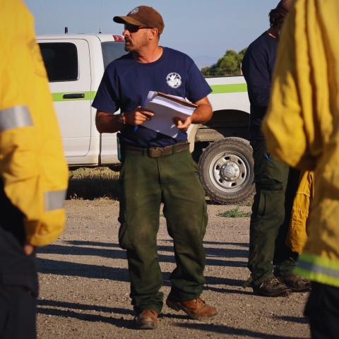 Engine Captain, Ron Sandling, briefs' firefighters before a prescribed burn.