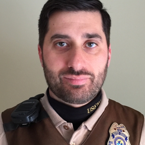 Man with beard and dark hair posing for photo