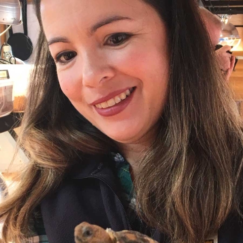 ./images/pages/catherine-phillips-bio.jpg" alt="A woman in a USFWS shirt holding a small turtle