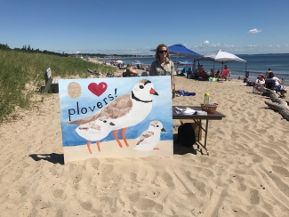 Intern conducts public outreach event at Rachel Carson NWR on a beach in Maine.