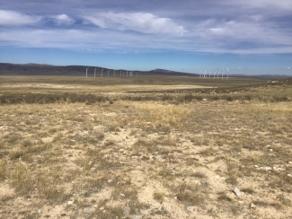 wind turbines in background of rocky Wyoming plains