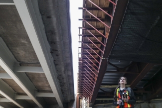 Biologist standing beneath a pair of bridges.