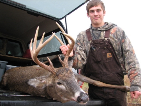 Teenage deer hunter with harvested deer at Big Oaks NWR