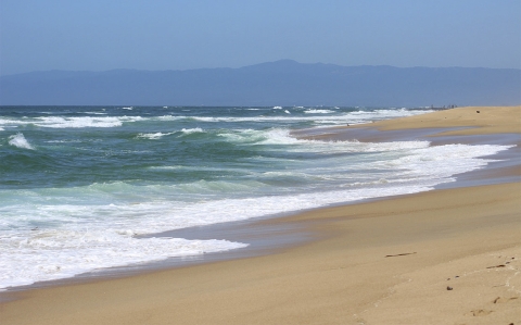 a beach with rolling waves