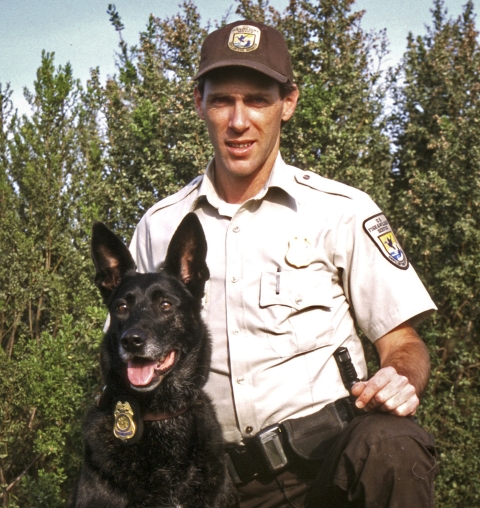 a man and a dog pose for a picture