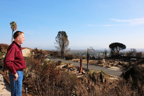 A man in a red shirt overlooking the lanscape