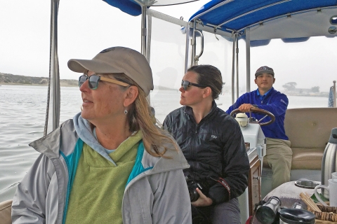 A woman looking out the window of a boat