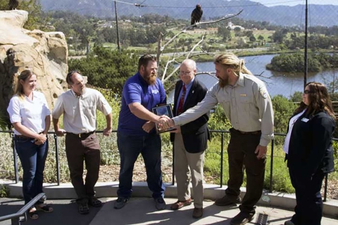 A group of people stand on an outdoor stage