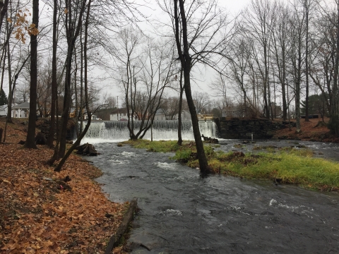 Water flows over a dam. 