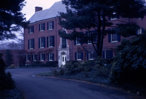 Large estate home with fine tree in foreground