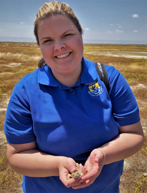 A woman holds a blunt-nosed leopard lizard in her hands.