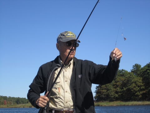 Fisherman baits his hook