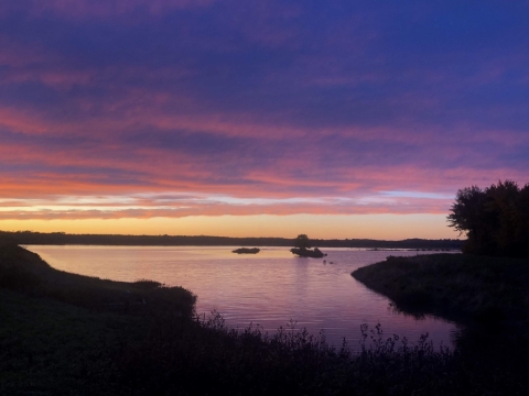 purple, blue, and orange sunset of clam water