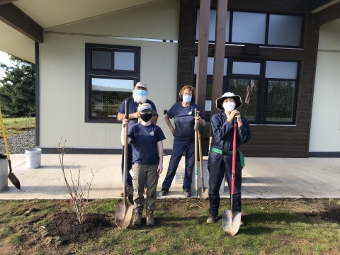 Volunteers planting Western Azalea at the new Bandon Marsh Office.