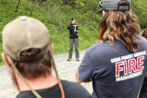 Biologist standing in front of a group, addressing them.