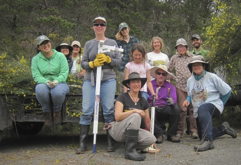 a group of people posing for a photo outside