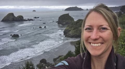 a woman taking a selfie at the ocean.