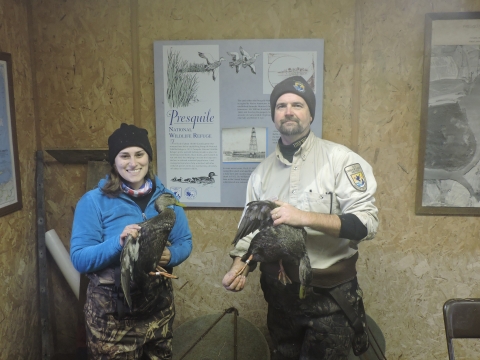 Refuge staff holding black ducks